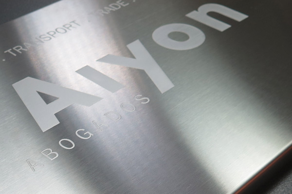 Stainless steel signs on a cut-out plate for Aiyon Abogados, an international law firm based in Spain specialized in transport and maritime law.
